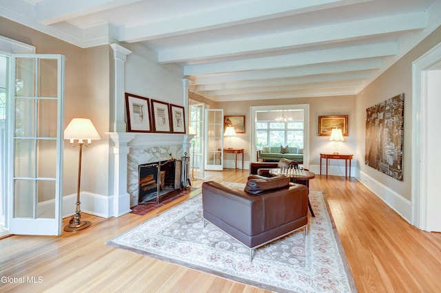 1171 Lowell Rd, Schenectady, NY 12308 - living room with beamed ceiling, wood finished floors, a premium fireplace, and decorative columns