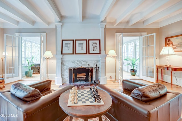 1171 Lowell Rd, Schenectady, NY 12308 - living area with beamed ceiling, wood finished floors, ornamental molding, decorative columns, and a high end fireplace