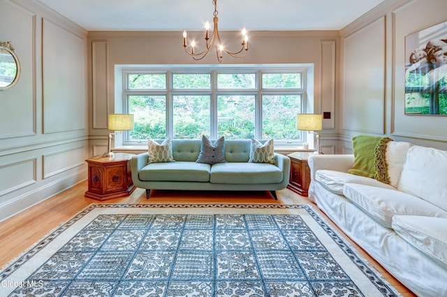 1171 Lowell Rd, Schenectady, NY 12308 - living area featuring a decorative wall, healthy amount of natural light, light wood-style floors, a chandelier, and ornamental molding