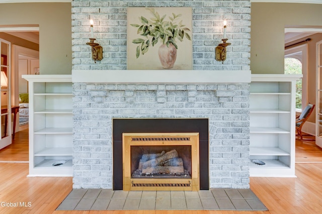 1171 Lowell Rd, Schenectady, NY 12308 - detailed view of a brick fireplace, wood finished floors, and crown molding