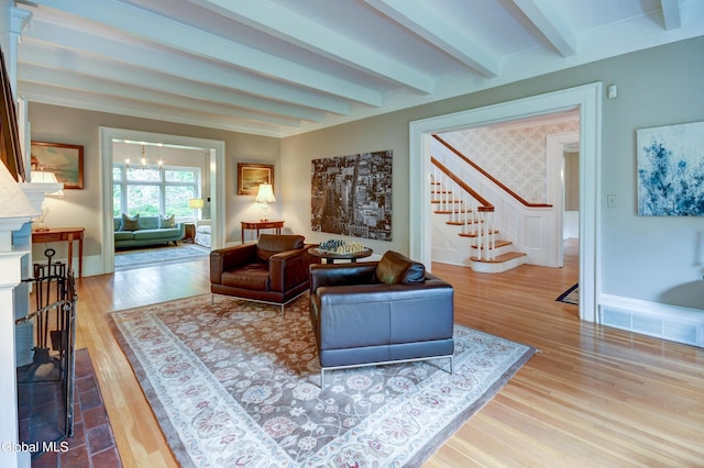 1171 Lowell Rd, Schenectady, NY 12308 - living room with stairway, beamed ceiling, wood finished floors, a fireplace, and a chandelier