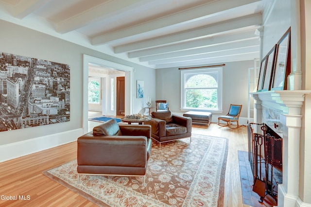 1171 Lowell Rd, Schenectady, NY 12308 - living area with a fireplace, wood finished floors, and beamed ceiling