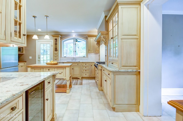 1171 Lowell Rd, Schenectady, NY 12308 - kitchen with wine cooler, ornamental molding, cream cabinets, glass insert cabinets, and hanging light fixtures