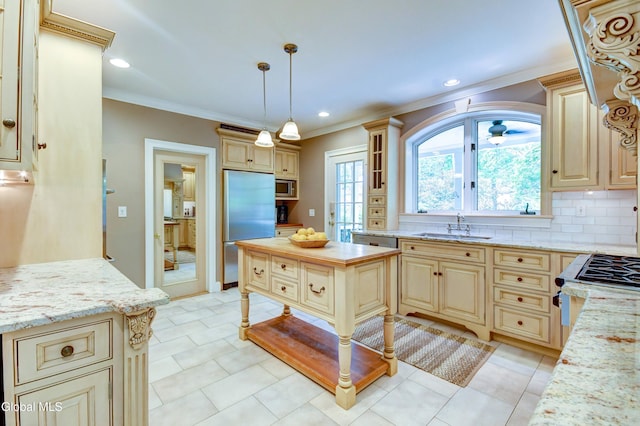 1171 Lowell Rd, Schenectady, NY 12308 - kitchen with built in appliances, cream cabinets, ornamental molding, light stone countertops, and decorative light fixtures