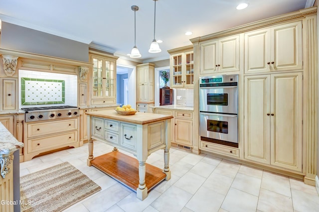 1171 Lowell Rd, Schenectady, NY 12308 - kitchen with cream cabinetry, double oven, pendant lighting, recessed lighting, and light stone countertops