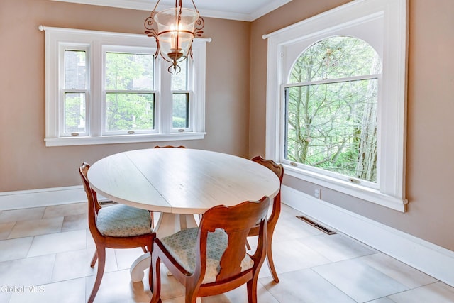 1171 Lowell Rd, Schenectady, NY 12308 - dining space with a chandelier, ornamental molding, and light tile patterned flooring