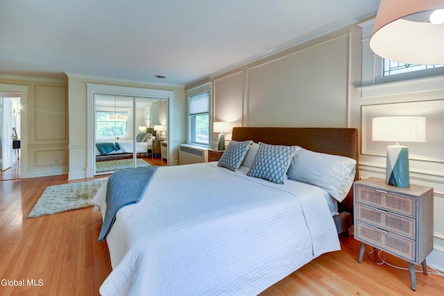 1171 Lowell Rd, Schenectady, NY 12308 - bedroom with a decorative wall, wood finished floors, crown molding, and a closet