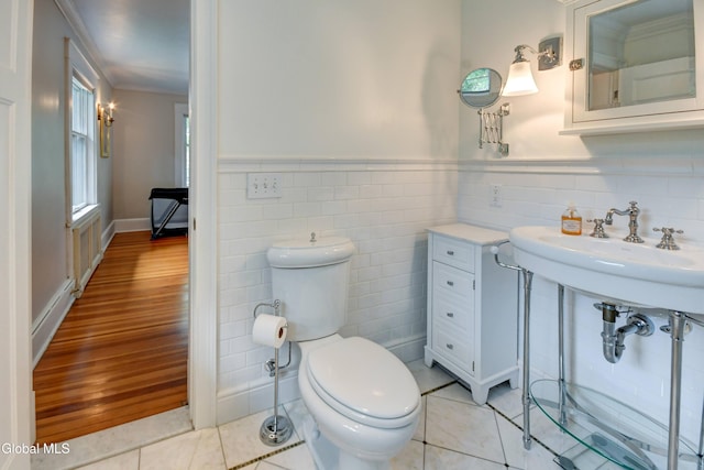 1171 Lowell Rd, Schenectady, NY 12308 - bathroom featuring tile walls, ornamental molding, wainscoting, and tile patterned floors