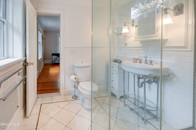 1171 Lowell Rd, Schenectady, NY 12308 - bathroom featuring tile patterned floors, tile walls, a wainscoted wall, and crown molding