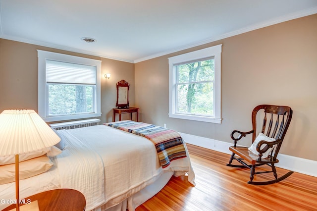 1171 Lowell Rd, Schenectady, NY 12308 - bedroom featuring radiator heating unit, wood finished floors, and crown molding