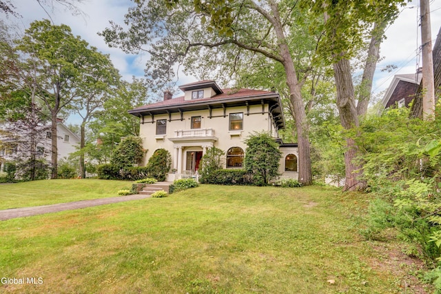 1171 Lowell Rd, Schenectady, NY 12308 - view of front of house with stucco siding, a front lawn, a balcony, and a chimney