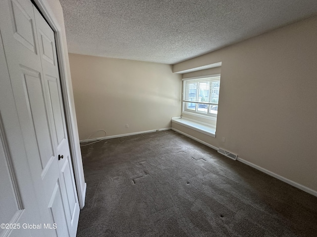 11 Derby Dr, Saratoga Springs, NY 12866 - unfurnished room featuring a textured ceiling and dark carpet