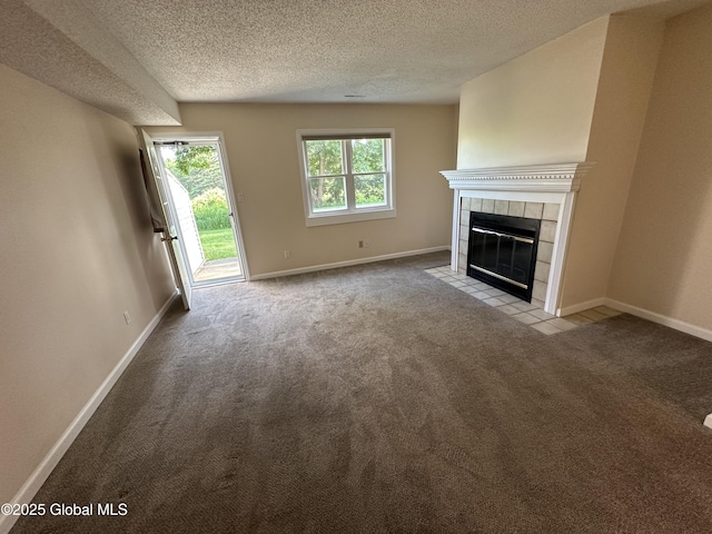 11 Derby Dr, Saratoga Springs, NY 12866 - unfurnished living room with carpet flooring, a textured ceiling, and a tile fireplace