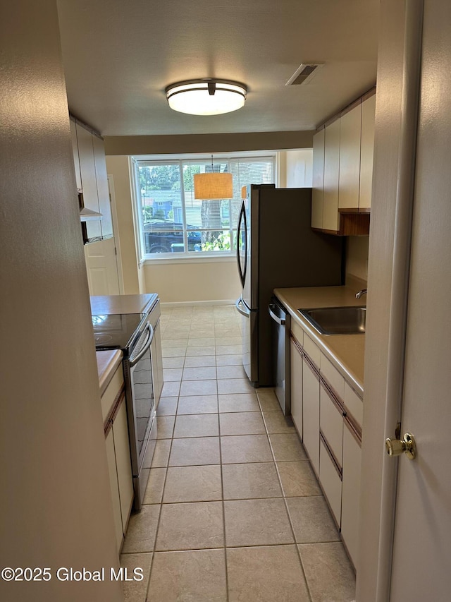 11 Derby Dr, Saratoga Springs, NY 12866 - kitchen featuring appliances with stainless steel finishes, light tile patterned floors, and white cabinets