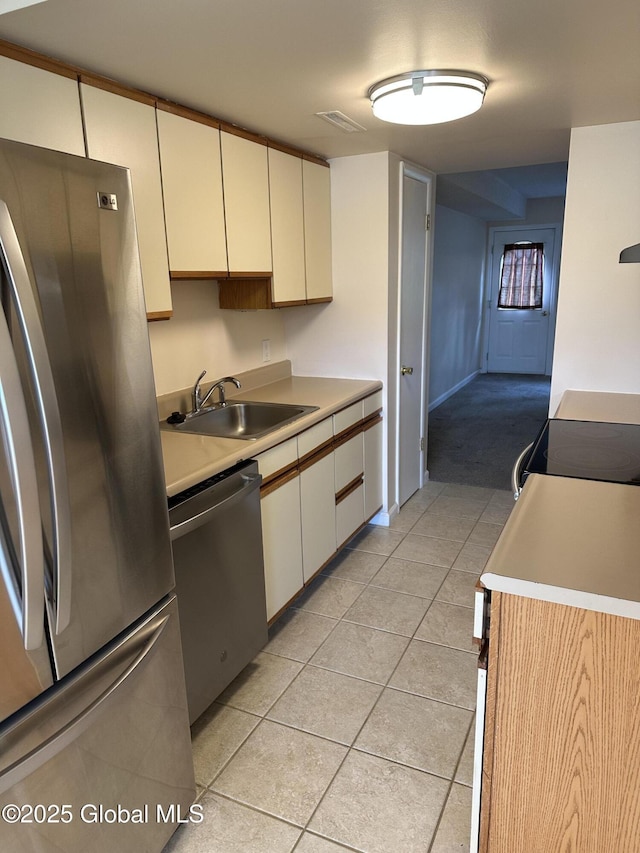 11 Derby Dr, Saratoga Springs, NY 12866 - kitchen with stainless steel appliances, light countertops, and light tile patterned floors