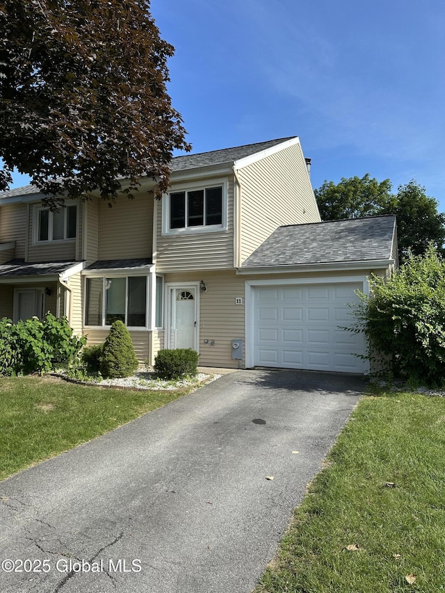 11 Derby Dr, Saratoga Springs, NY 12866 - view of front facade with asphalt driveway, an attached garage, and a front lawn