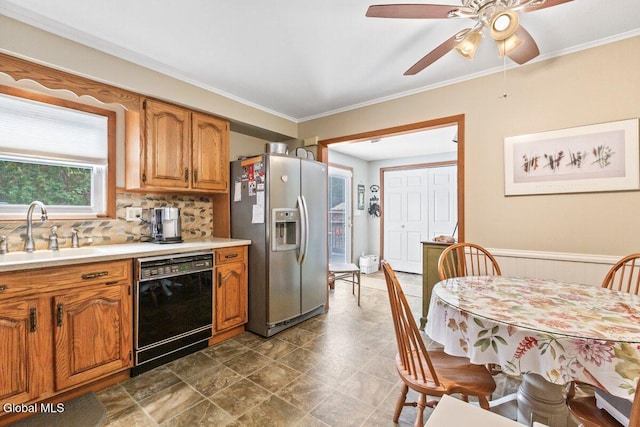 236 Cherry St, Schenectady, NY 12306 - kitchen with black dishwasher, stainless steel fridge, brown cabinets, light countertops, and ornamental molding