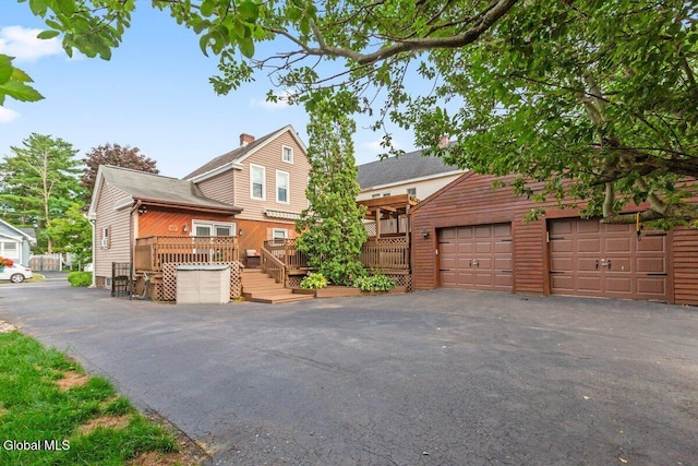 236 Cherry St, Schenectady, NY 12306 - view of front of property featuring a deck, a garage, and a chimney