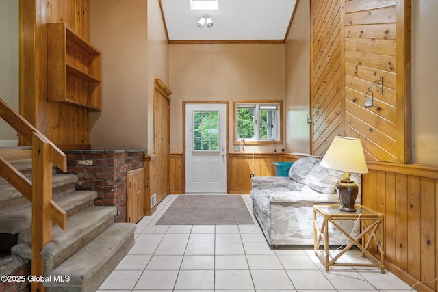 1927 Berne Altamont Rd, Altamont, NY 12009 - entrance foyer featuring wood walls, a wainscoted wall, stairs, ornamental molding, and light tile patterned flooring