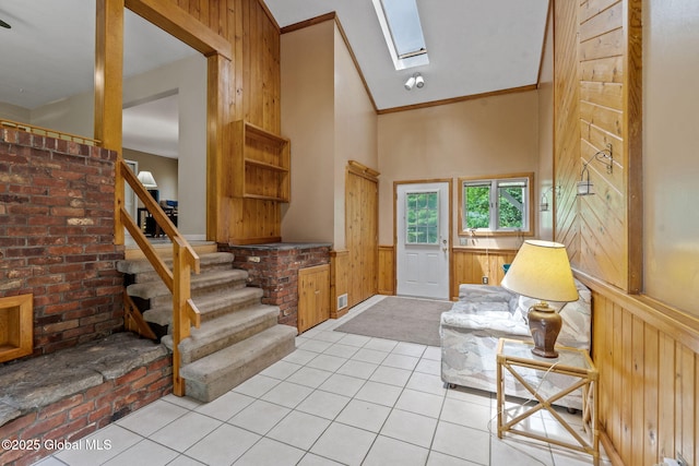 1927 Berne Altamont Rd, Altamont, NY 12009 - foyer with a skylight, a wainscoted wall, stairway, wooden walls, and tile patterned flooring