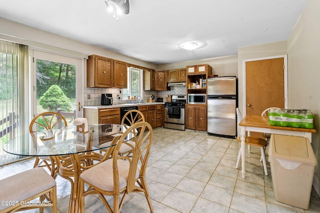 1927 Berne Altamont Rd, Altamont, NY 12009 - kitchen with appliances with stainless steel finishes, backsplash, light countertops, brown cabinets, and open shelves