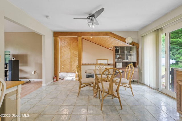 1927 Berne Altamont Rd, Altamont, NY 12009 - dining space with a ceiling fan, vaulted ceiling, light tile patterned flooring, and wood walls