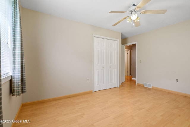 1927 Berne Altamont Rd, Altamont, NY 12009 - unfurnished bedroom featuring light wood-style floors, a closet, multiple windows, and ceiling fan