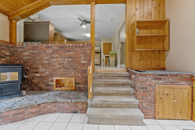 1927 Berne Altamont Rd, Altamont, NY 12009 - staircase with tile patterned floors, a wood stove, and ceiling fan