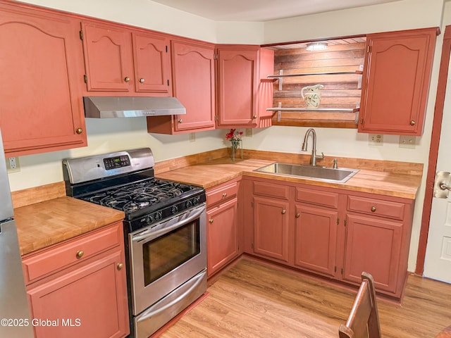 4882 Potter Hollow Rd, Rensselaerville, NY 12469 - kitchen with stainless steel gas range oven, under cabinet range hood, light wood finished floors, and open shelves