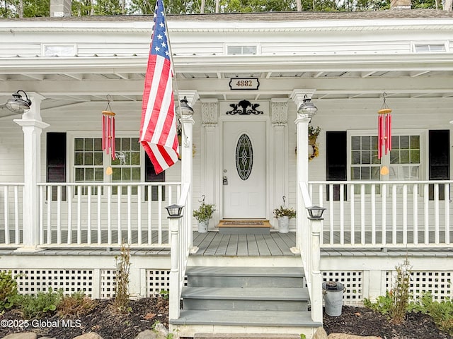 4882 Potter Hollow Rd, Rensselaerville, NY 12469 - property entrance with covered porch and a chimney