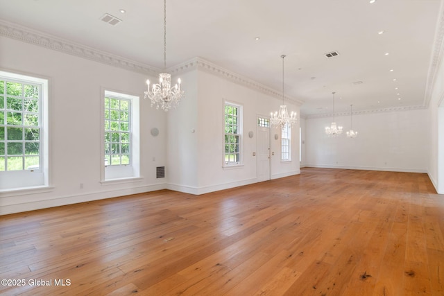 410 Jones Hill Rd, Jefferson, NY 12093 - unfurnished living room featuring a chandelier, light wood-style flooring, plenty of natural light, and ornamental molding