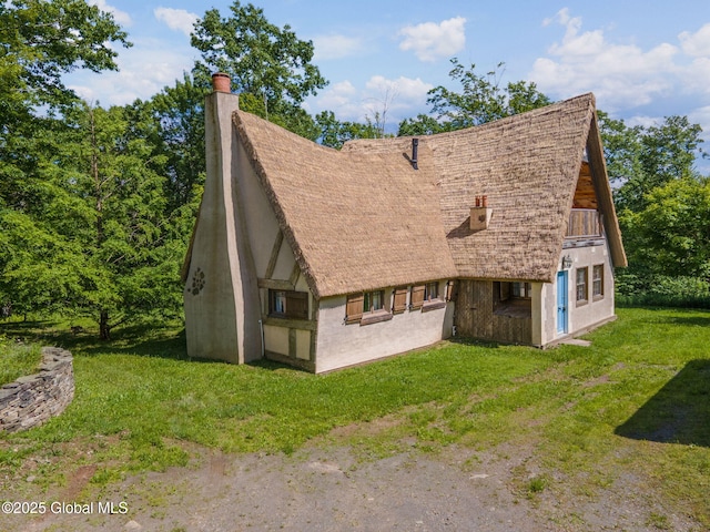 372 Jones Hill Rd, Jefferson, NY 12093 - view of side of home featuring a chimney and a lawn
