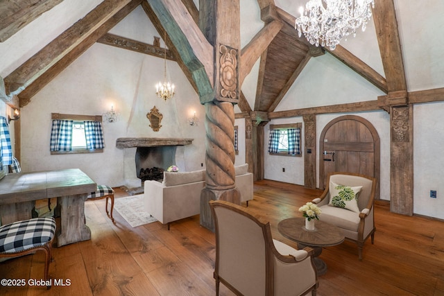 372 Jones Hill Rd, Jefferson, NY 12093 - living room featuring a chandelier, high vaulted ceiling, beam ceiling, hardwood / wood-style flooring, and plenty of natural light