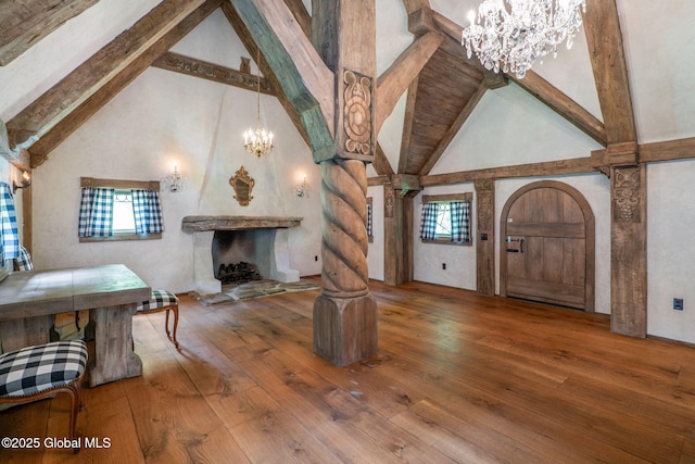 372 Jones Hill Rd, Jefferson, NY 12093 - living room with a chandelier, high vaulted ceiling, hardwood / wood-style flooring, beamed ceiling, and healthy amount of natural light