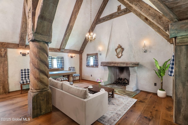 372 Jones Hill Rd, Jefferson, NY 12093 - living room featuring hardwood / wood-style flooring, beam ceiling, high vaulted ceiling, a chandelier, and a premium fireplace