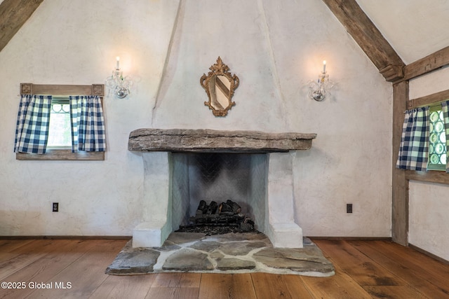 372 Jones Hill Rd, Jefferson, NY 12093 - detailed view of wood finished floors, beamed ceiling, and a fireplace with raised hearth