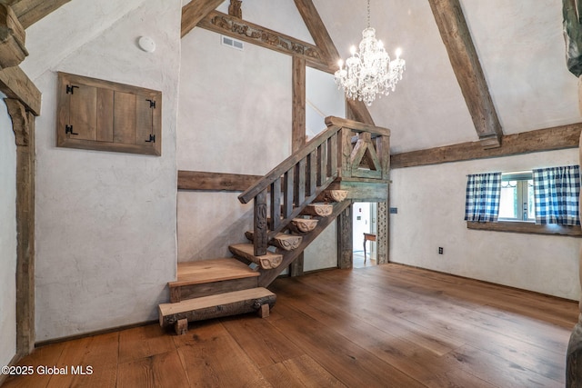 372 Jones Hill Rd, Jefferson, NY 12093 - staircase with wood-type flooring, beamed ceiling, a chandelier, and high vaulted ceiling