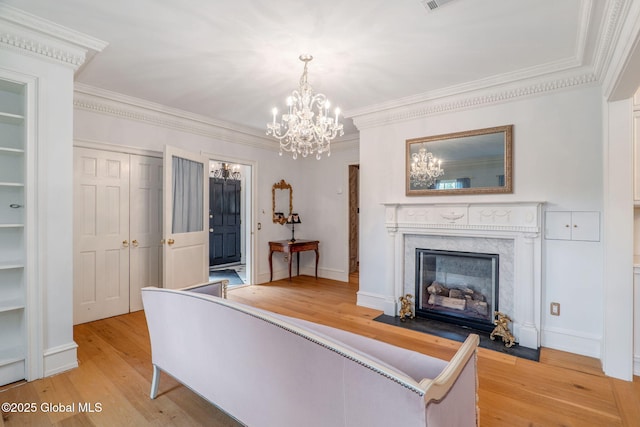 372 Jones Hill Rd, Jefferson, NY 12093 - living area with a chandelier, light wood finished floors, crown molding, and a premium fireplace