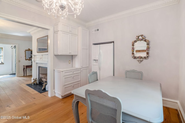372 Jones Hill Rd, Jefferson, NY 12093 - dining area with a chandelier, light wood-style flooring, and crown molding