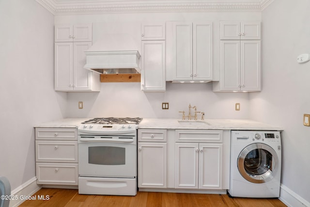 372 Jones Hill Rd, Jefferson, NY 12093 - kitchen featuring washer / clothes dryer, white gas range, custom exhaust hood, light wood finished floors, and light stone counters