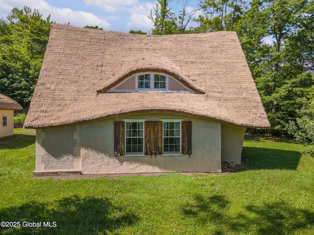 372 Jones Hill Rd, Jefferson, NY 12093 - back of house featuring stucco siding and a lawn
