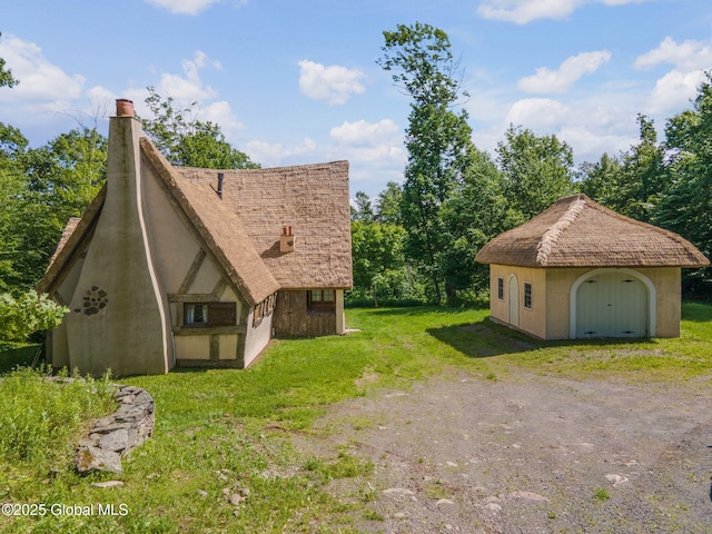 372 Jones Hill Rd, Jefferson, NY 12093 - view of side of home featuring a yard, stucco siding, and a storage shed