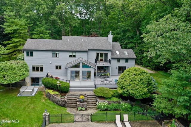 14 Friar Tuck Ct, Clifton Park, NY 12065 - rear view of house with a balcony, a fenced front yard, a chimney, and roof with shingles