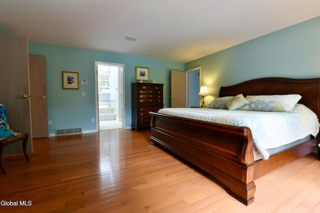 14 Friar Tuck Ct, Clifton Park, NY 12065 - bedroom with light wood-style flooring and connected bathroom