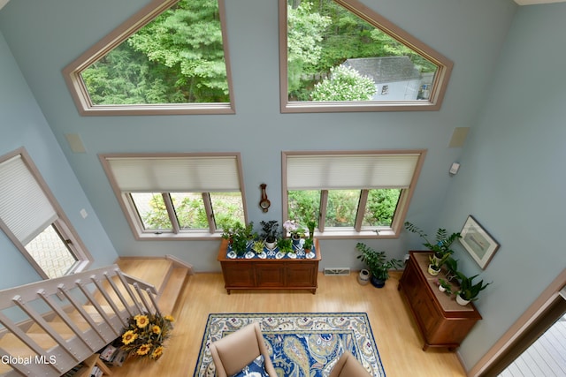 14 Friar Tuck Ct, Clifton Park, NY 12065 - living room featuring wood finished floors, a high ceiling, and stairs