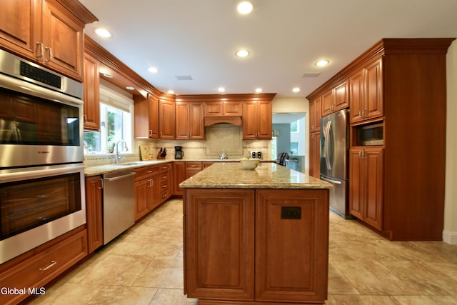 14 Friar Tuck Ct, Clifton Park, NY 12065 - kitchen with appliances with stainless steel finishes, a center island, light stone counters, tasteful backsplash, and recessed lighting