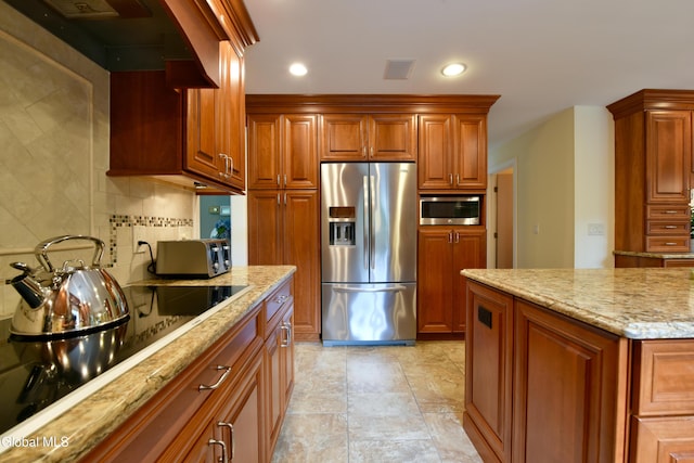 14 Friar Tuck Ct, Clifton Park, NY 12065 - kitchen featuring stainless steel appliances, backsplash, light stone counters, brown cabinetry, and recessed lighting