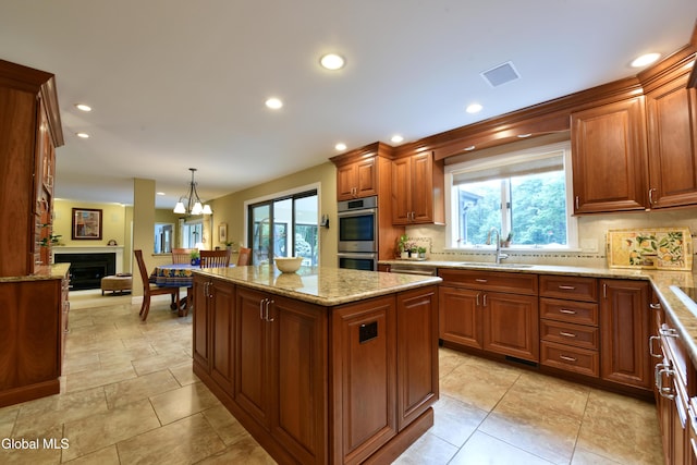 14 Friar Tuck Ct, Clifton Park, NY 12065 - kitchen featuring stainless steel double oven, backsplash, healthy amount of natural light, a center island, and recessed lighting