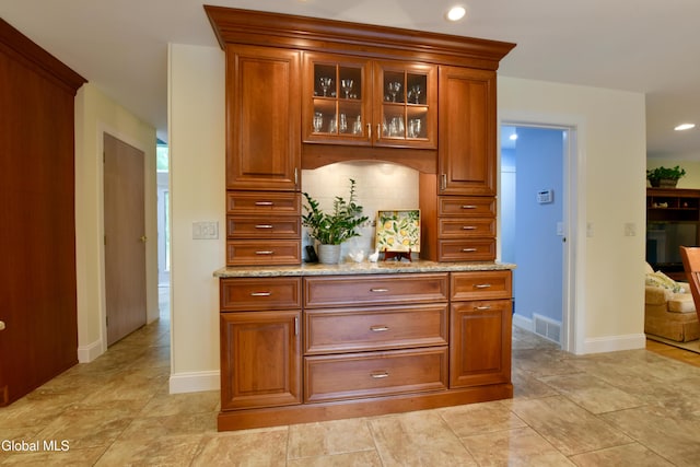 14 Friar Tuck Ct, Clifton Park, NY 12065 - kitchen with light stone counters, tasteful backsplash, glass insert cabinets, brown cabinets, and recessed lighting