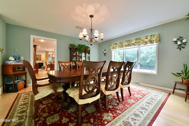 14 Friar Tuck Ct, Clifton Park, NY 12065 - dining room with a chandelier and light wood finished floors